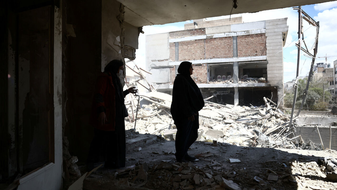 A woman stands in her brother's home, which was damaged by a strike, as the U.S.-Israeli conflict with Iran continues, in Tehran, Iran, March 30, 2026. Majid Asgaripour/WANA (West Asia News Agency) via REUTERS