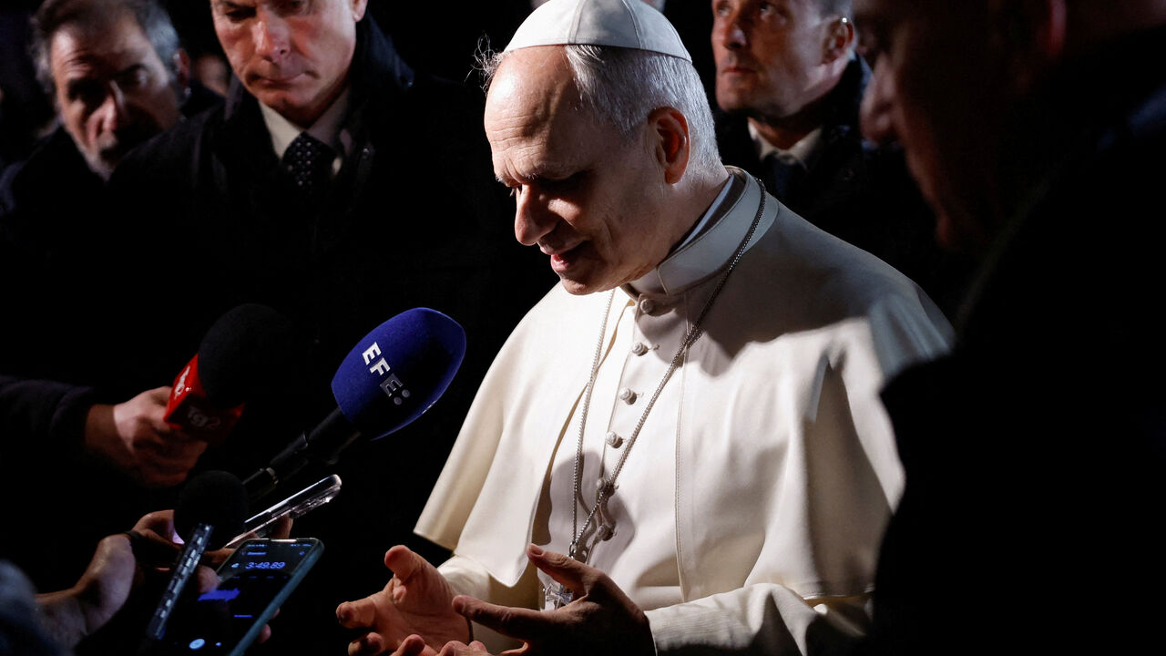 Pope Leo XIV speaks to the media as he leaves the papal residence to head back to the Vatican, in Castel Gandolfo, Italy, March 31, 2026. REUTERS/Remo Casilli