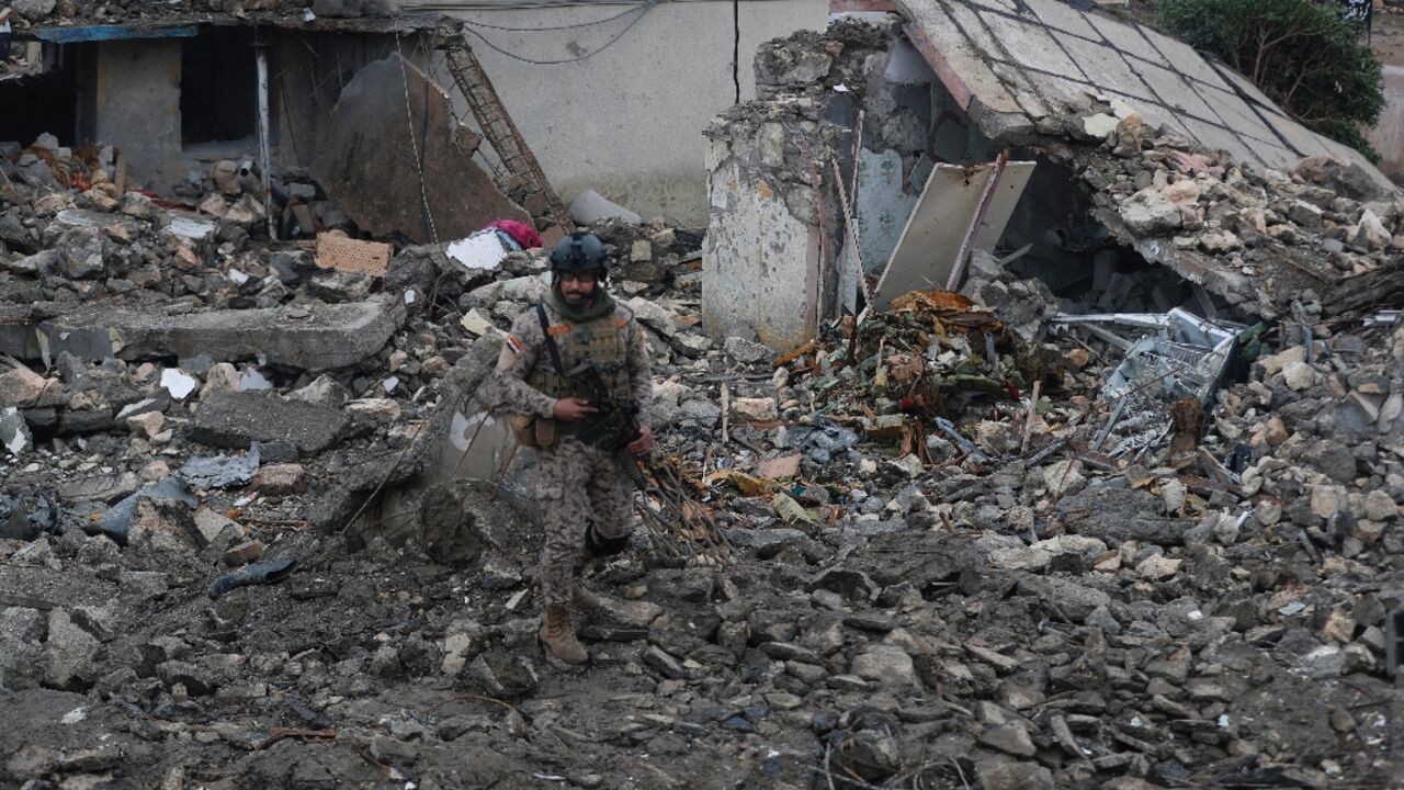 An Iraqi soldier guards the site of the destroyed health centre at the Habbaniyah military base
