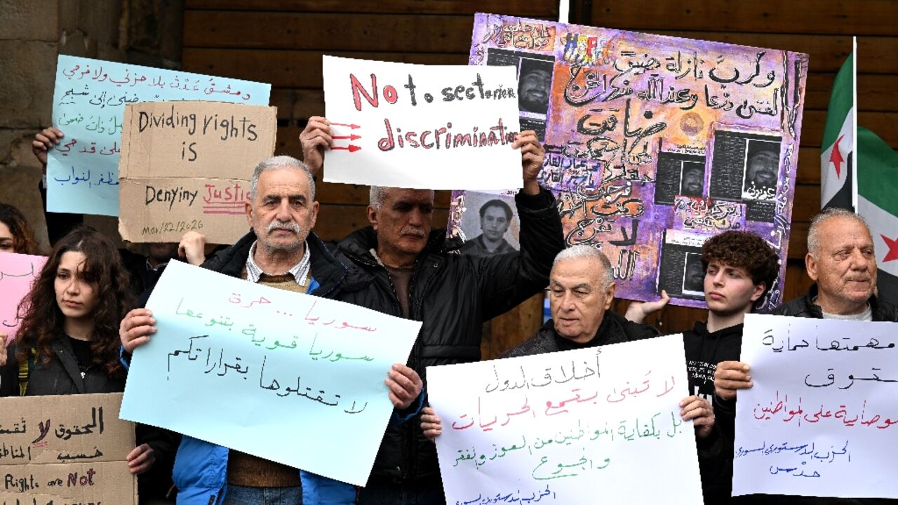 Syrians hold a silent protest against an official decision banning the sale of alcohol outside of certain areas