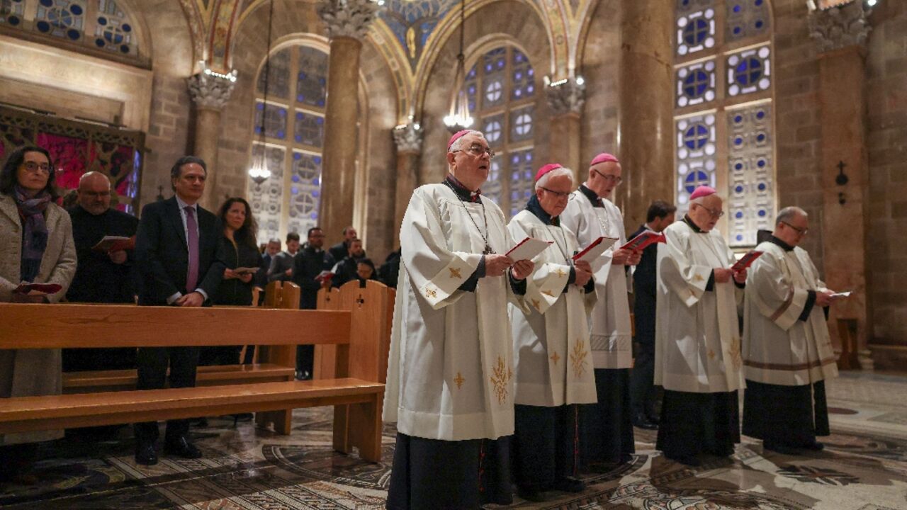 Members of the clergy and faithfuls attend a prayer service in the Church of All Nations held by Latin Patriarch of Jerusalem, Cardinal Pierbattista Pizzaballa, to mark Palm Sunday in Jerusalem