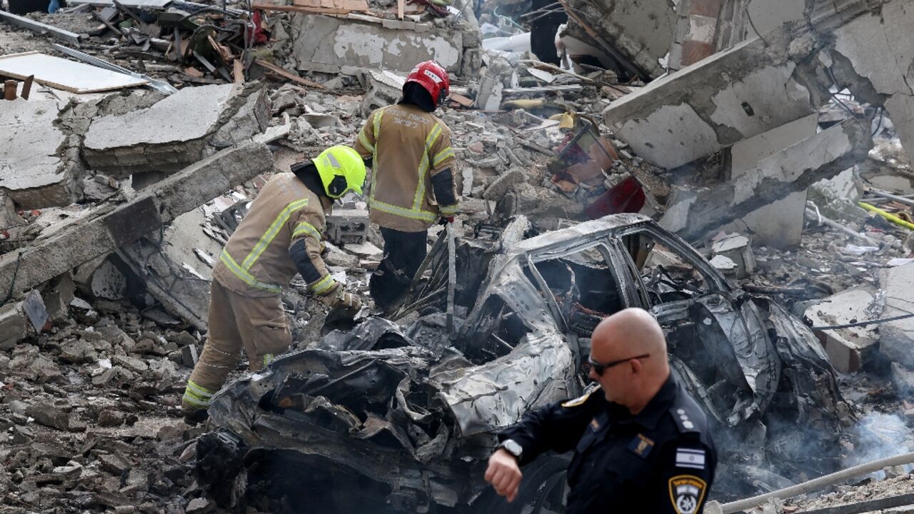 Israeli rescue teams still search for missing people after a deadly Iranian missile strike 