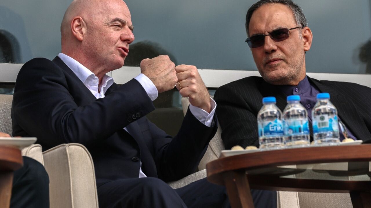 FIFA's President Gianni Infantino (L) makes a point as he watches Iran beat Costa Rica in Antalya, Turkey