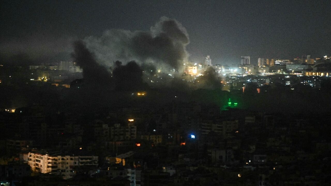 A plume of smoke rises from the site of an Israeli airstrike in the southern suburbs of Beirut early on March 12
