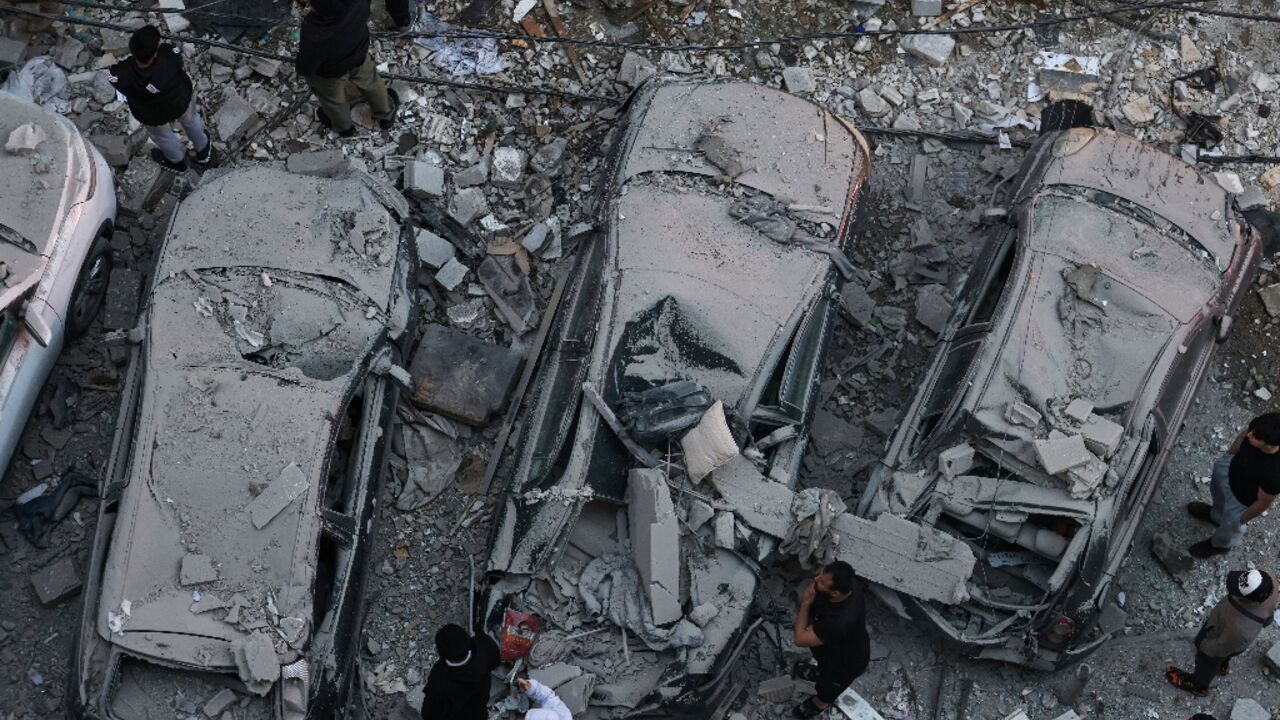 Residents gather at the site of an Israeli airstrike that targeted a building in the Aisha Bakkar neighbourhood of Beirut