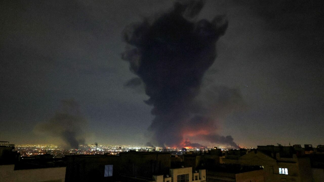 Smoke rises from Mehrabad International Airport in Tehran as the Mideast war enter its second week