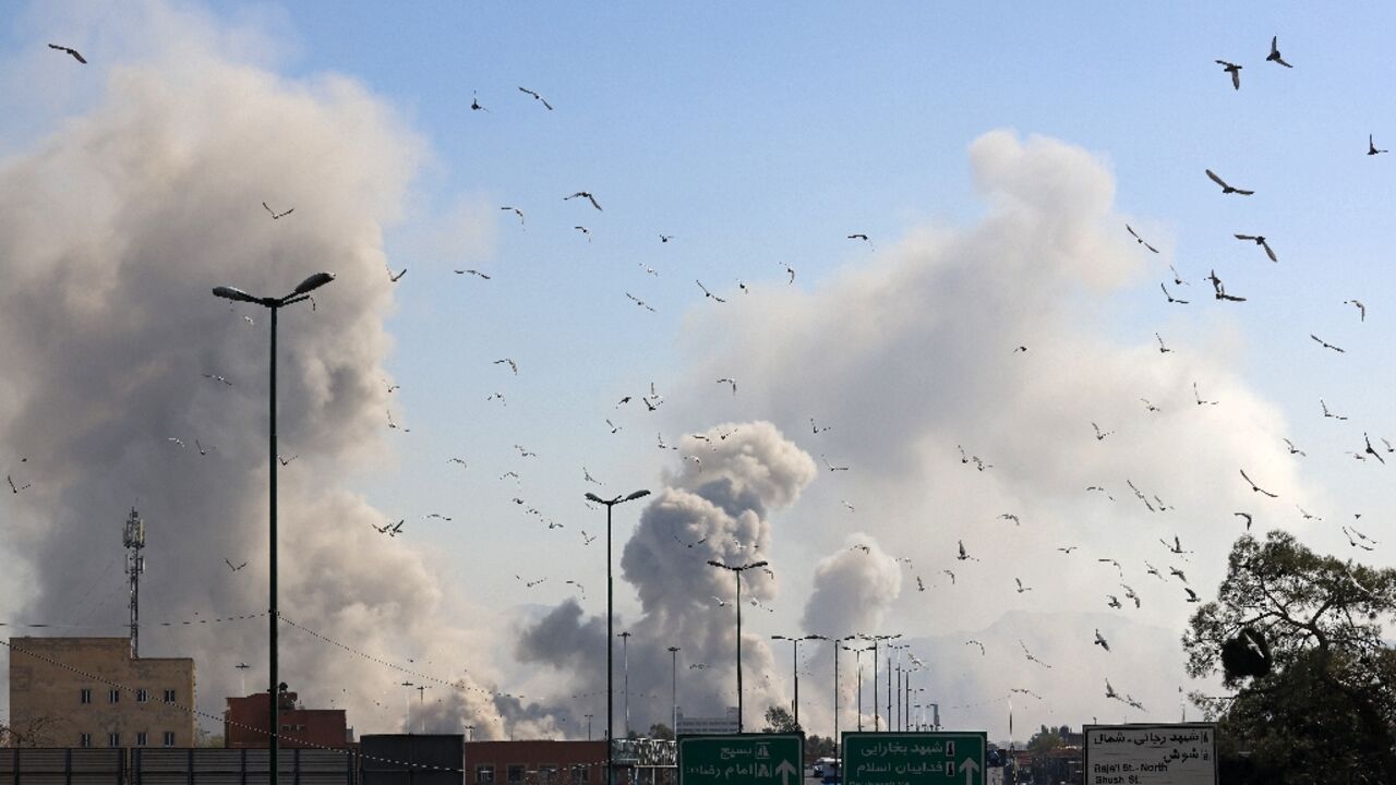 A plume of smoke rises after a strike on Tehran