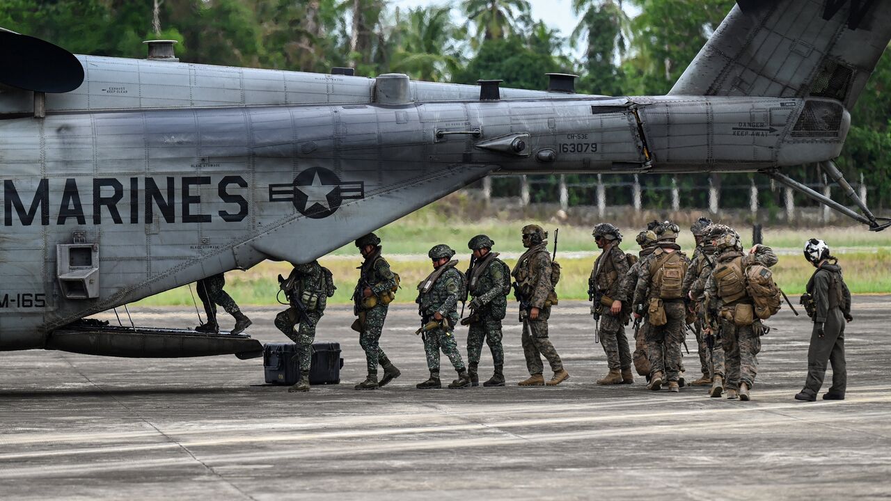 Soldiers board a US Marines CH-53 Super Stallion during an airfield seizure exercise as part of the US-Philippines Balikatan joint military exercise at San Vicente Airport in Palawan on May 1, 2024. 