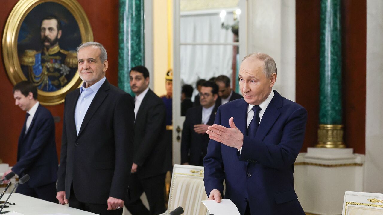 In this pool photograph distributed by the Russian state agency Sputnik, Russia's Russian President Vladimir Putin and Iranian President Masoud Pezeshkian arrive for a documents signing ceremony following their talks at the Kremlin in Moscow on January 17, 2025. (Photo by Vyacheslav PROKOFYEV / POOL / AFP) (Photo by VYACHESLAV PROKOFYEV/POOL/AFP via Getty Images)