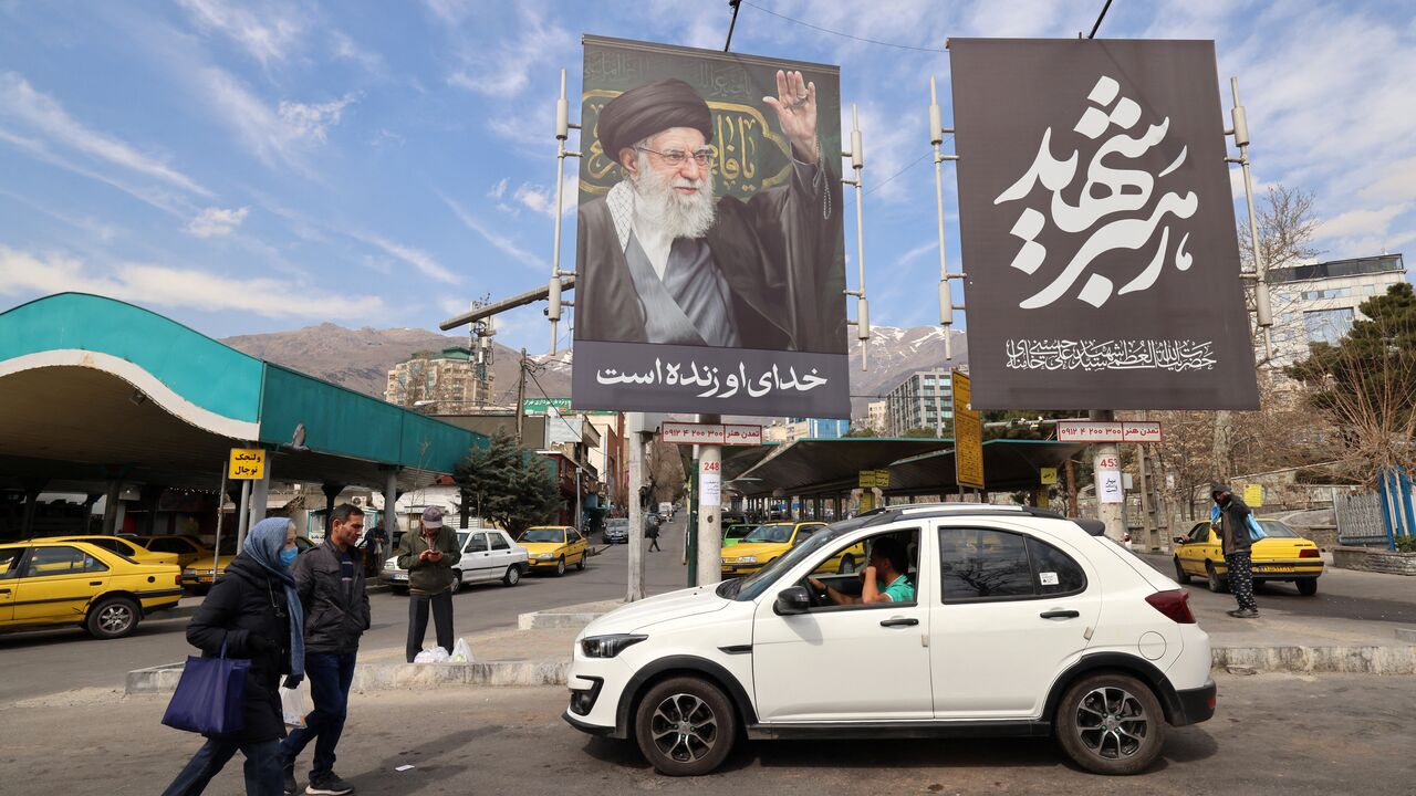 A large banner with the image of Iran's slain supreme leader Ayatollah Ali Khamenei adorns a main taxi rank close to Tajrish Square, one week on from the start of the US-Israel attack on Iran, in Tehran on March 7, 2026. 