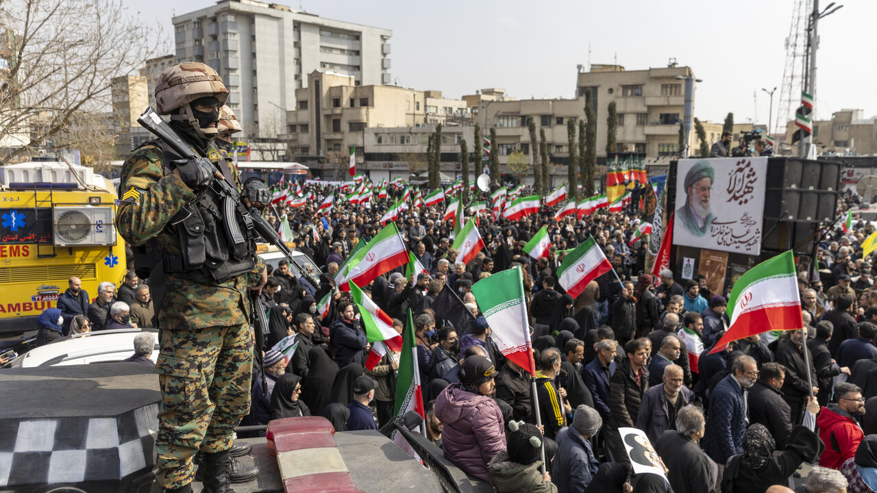 Soldiers stand guard as unerals are held for members of Iran's Revolutionary Guards Corps (IRGC) and other military figures at Enghelab Square on March 11, 2026 in Tehran, Iran.