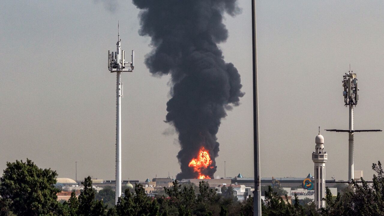 A smoke plume rises from an ongoing fire near Dubai International Airport in Dubai on March 16, 2026.