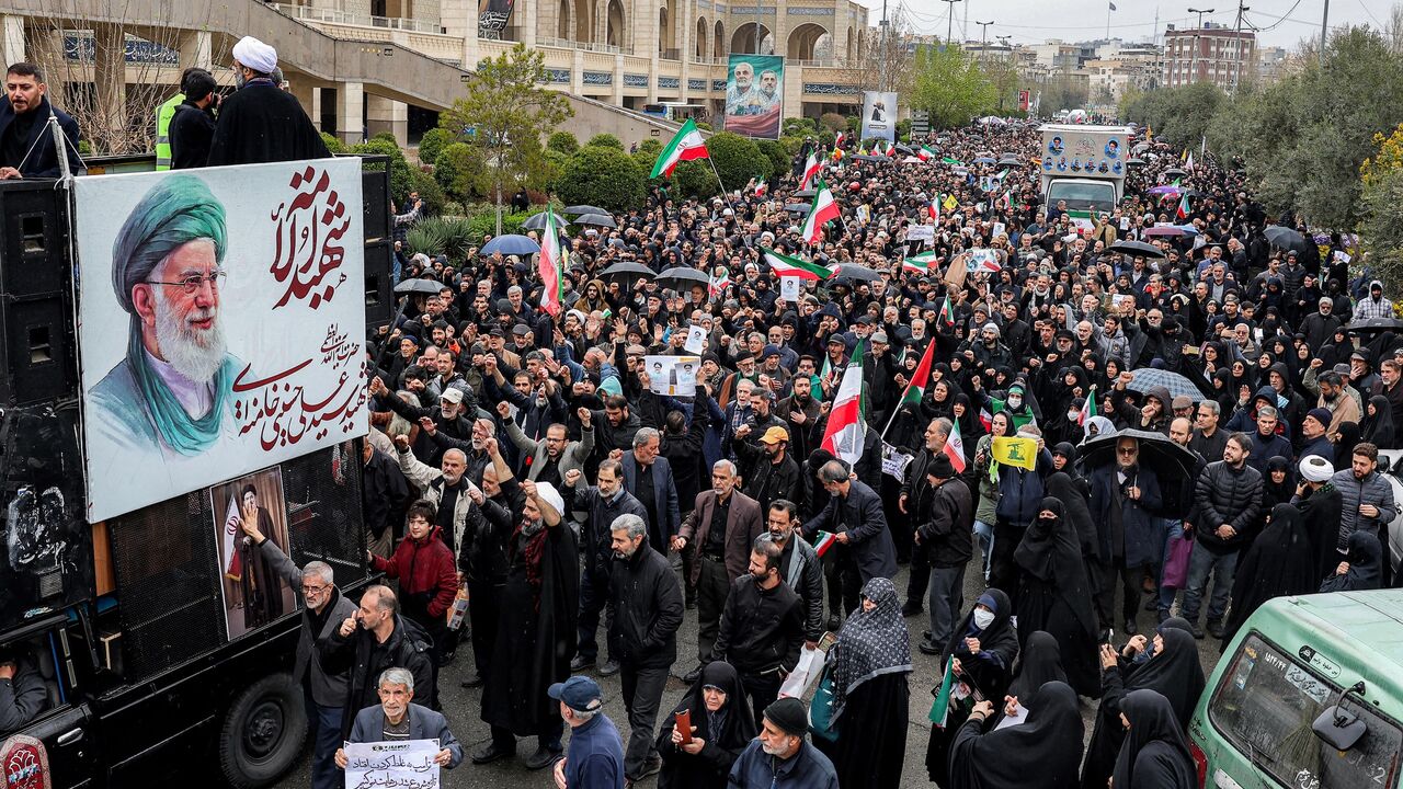 Mourners march during the funeral ceremony for Iran's slain intelligence minister, Esmail Khatib, and his family after the weekly Friday Muslim noon prayers in Tehran, on March 20, 2026. 