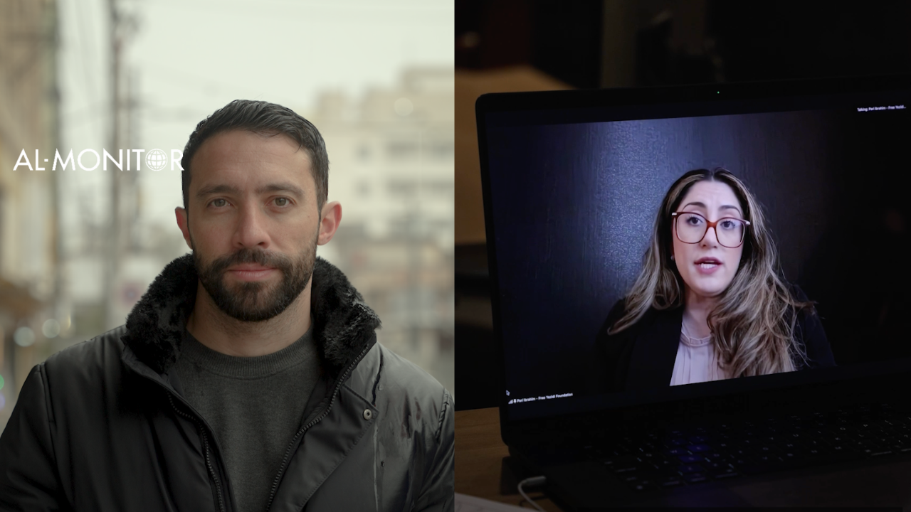 Joe Snell appears on a street wearing a black jacket; in the frame next to it, a woman with blonde hair, glasses, and a black blazer appears on a laptop screen from a Zoom meeting.