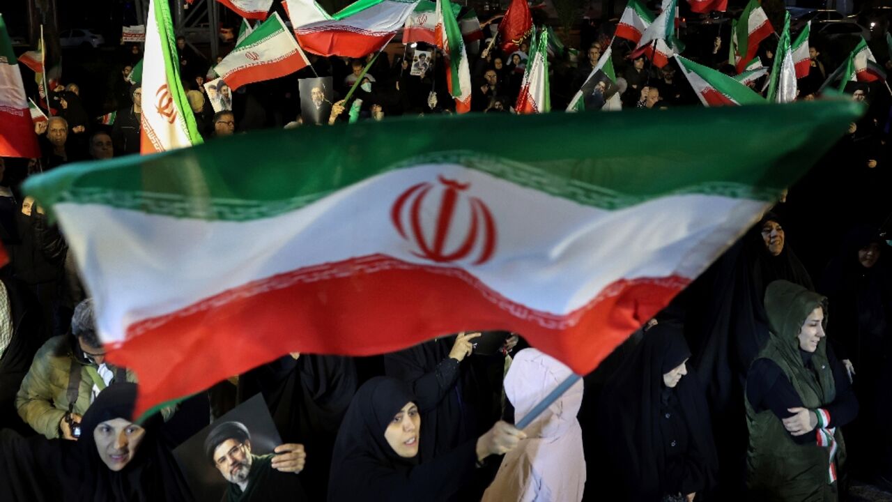 Iranians waved national flags and portraits of supreme leader Mojtaba Khamenei as they march in support of the country's armed forces in the capital Tehran