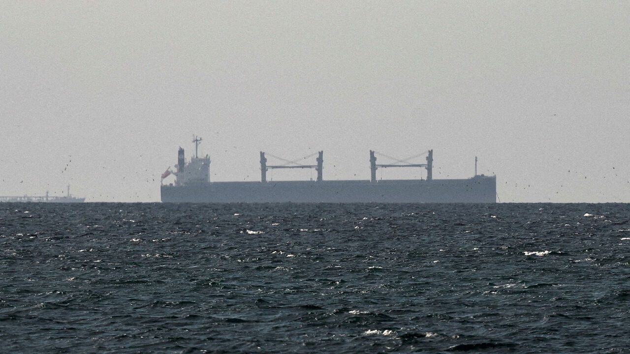FILE PHOTO: A cargo ship in the Gulf, near the Strait of Hormuz, as seen from northern Ras al-Khaimah, near the border with Oman’s Musandam governance, amid the U.S.-Israeli conflict with Iran, in United Arab Emirates, March 11, 2026. REUTERS/Stringer/File Photo