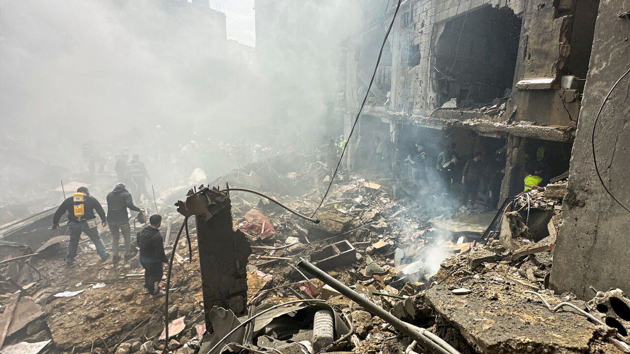 People gather as rescuers work at the site of an Israeli strike, amid escalating hostilities between Israel and Hezbollah, as the U.S.-Israel conflict with Iran continues, in the Jnah area in Beirut, Lebanon, April 5, 2026. REUTERS/Stringer