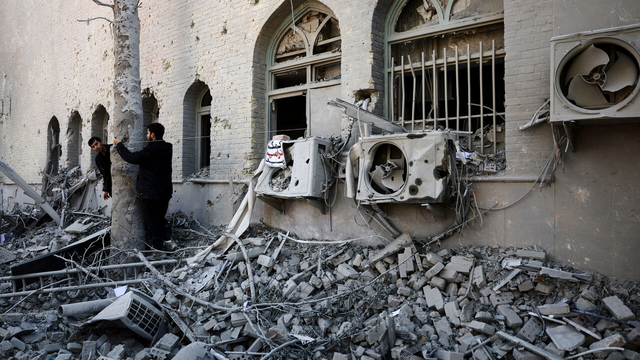 People stand amidst the rubble of a building of the Sharif University of Technology, which was damaged in a strike, amid the U.S.-Israeli conflict with Iran, in Tehran, Iran, April 7, 2026. Majid Asgaripour/WANA (West Asia News Agency) via REUTERS