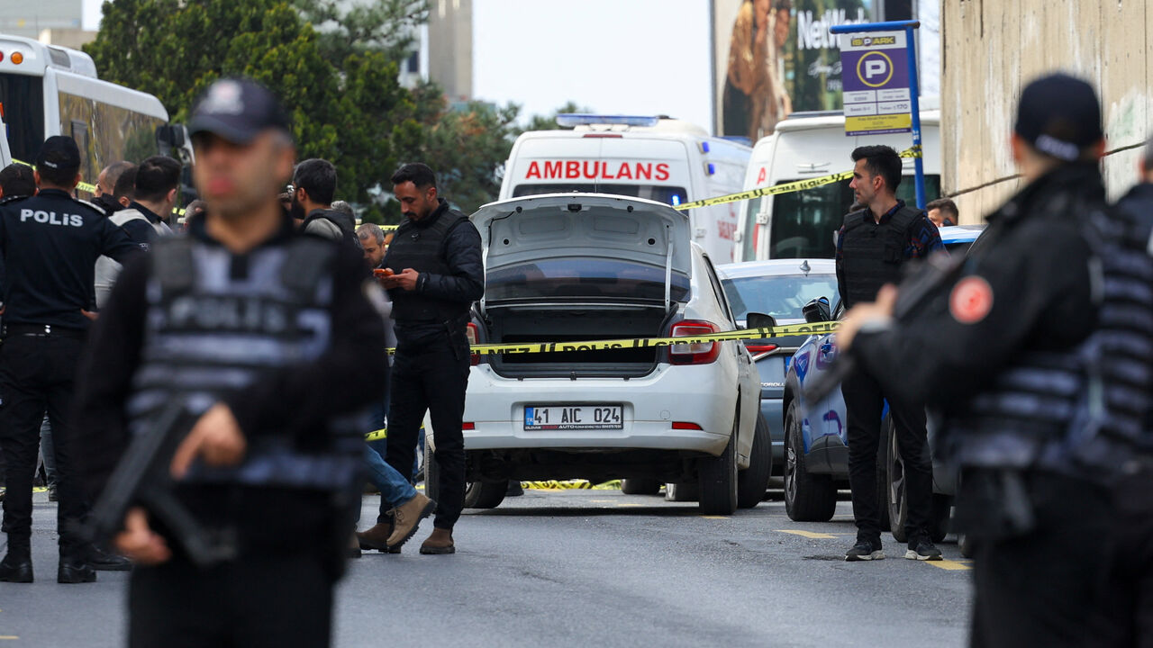 Police officers search a car at the scene, after gunfire was heard near the building housing the Israeli consulate, according to a witness, in Istanbul, Turkey, April 7, 2026. REUTERS/Murad Sezer