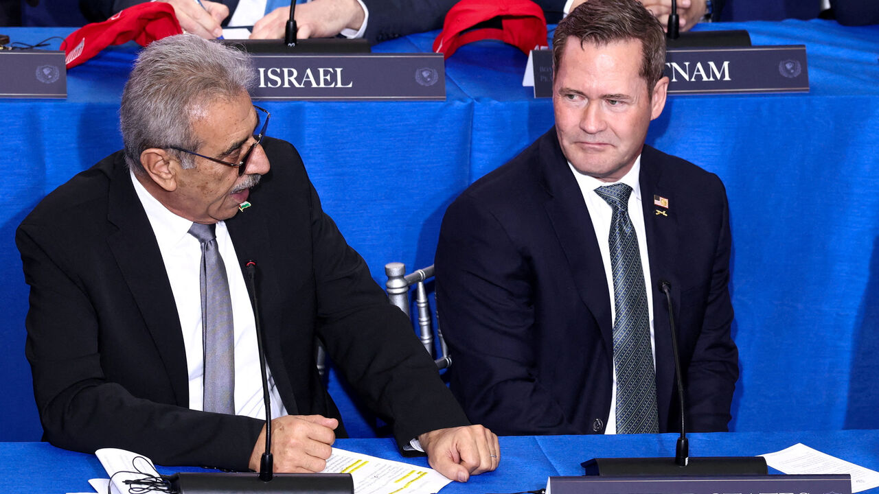 FILE PHOTO: U.S. Ambassador to the United Nations Mike Waltz and Chair of the Palestinian National Committee for the Administration of Gaza, Ali Shaath attend the inaugural Board of Peace meeting at the U.S. Institute of Peace in Washington, D.C., U.S., February 19, 2026. REUTERS/Kevin Lamarque/File Photo
