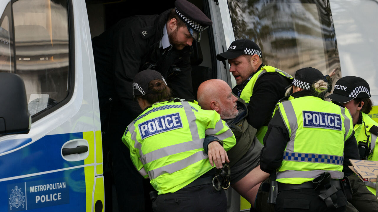 Police officers detain a protester at 'Everyone Day', a mass vigil and sign-holding event in Trafalgar Square organised by Defend Our Juries to demand the lifting of the ban on Palestine Action, in London, Britain, April 11, 2026. REUTERS/Jack Taylor