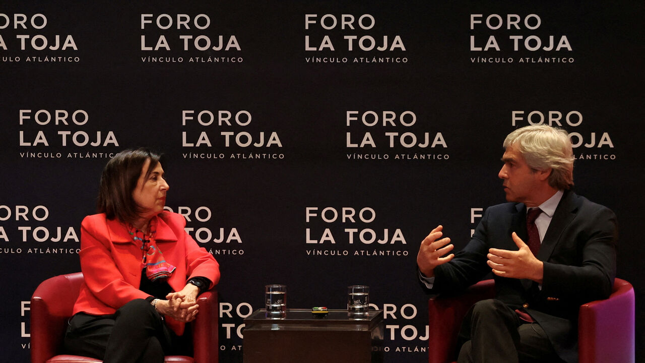 FILE PHOTO: Portuguese Defence Minister, Nuno Melo speaks with Spanish Defence Minister Margarita Robles during the La Toja Forum on global challenges in Lisbon, Portugal, April 1, 2025. REUTERS/Pedro Nunes/File Photo