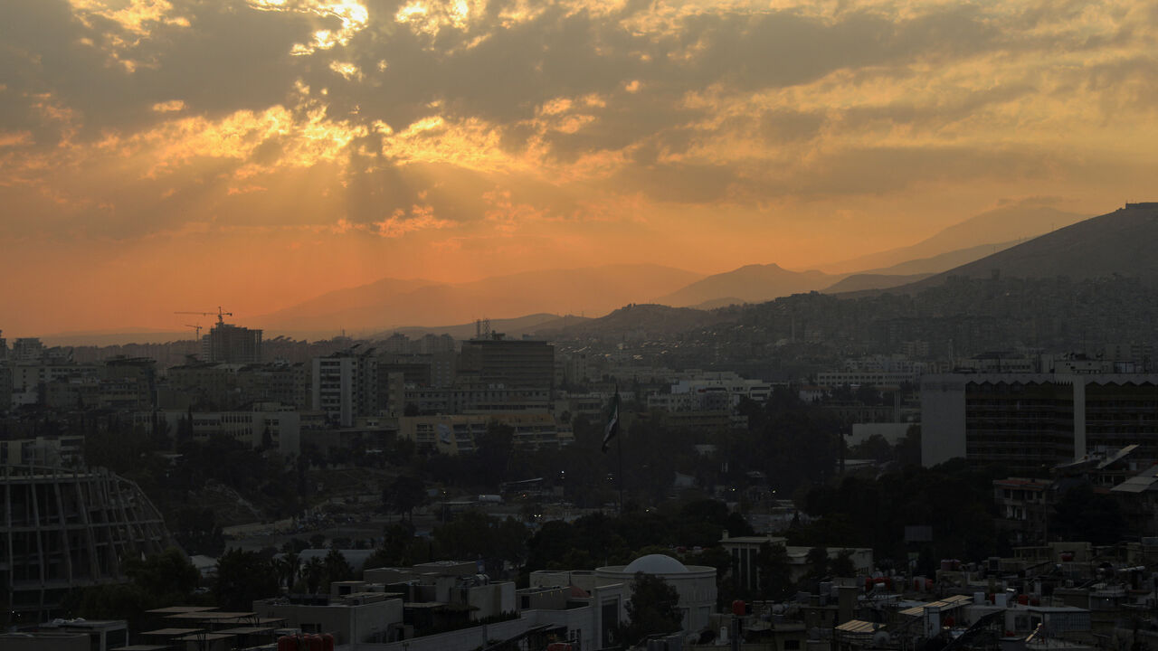 The sun sets over the skyline of Damascus, Syria, November 18, 2025. REUTERS/Orhan Qereman