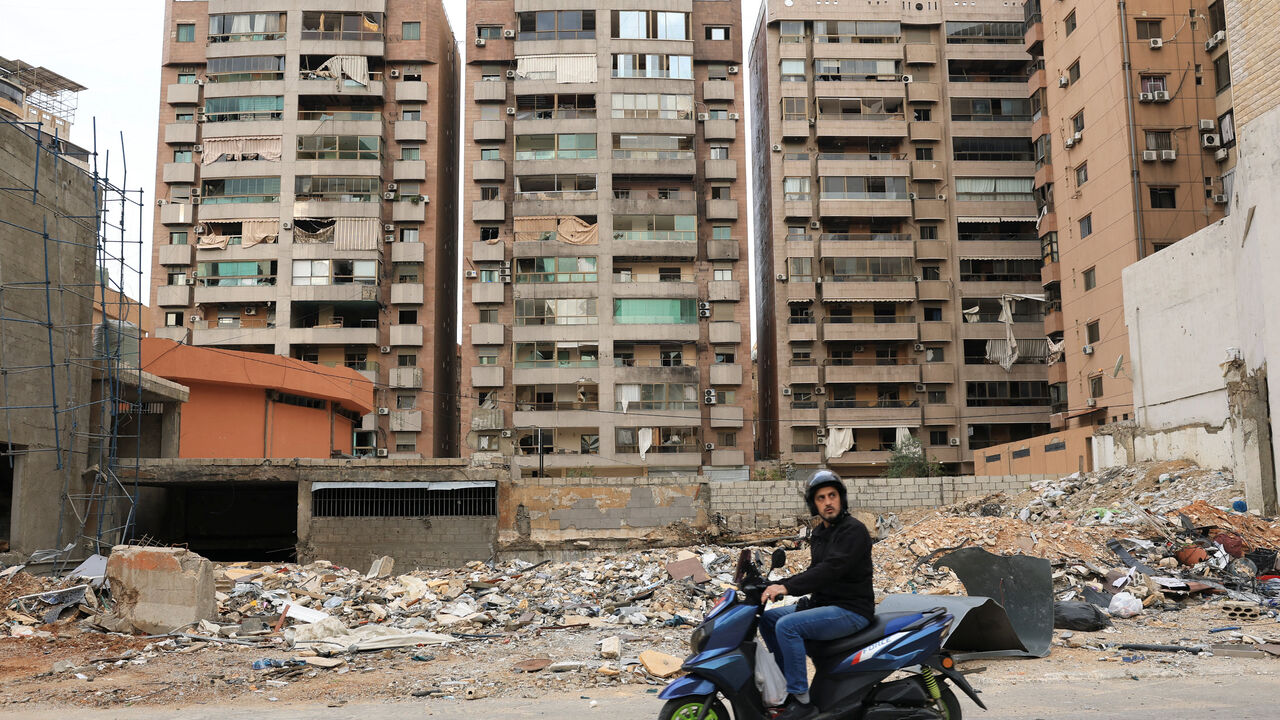 A man rides past a damaged building, as displaced people make their way as they return to their homes after a 10-day ceasefire between Lebanon and Israel went into effect, at the southern suburbs of Beirut, Lebanon, April 17, 2026. REUTERS/Adnan Abidi