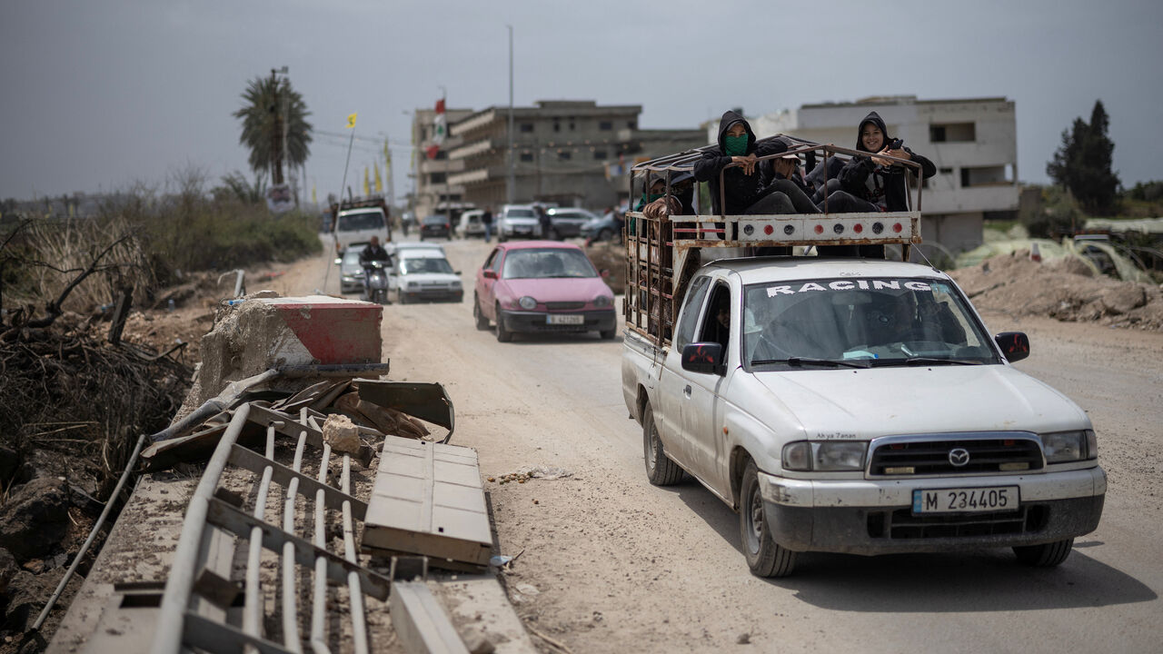 People travel in vehicles as displaced people make their way back to their home crossing the bridge linking southern Lebanon to the rest of the country, which was hit earlier in an Israeli strike, amid a 10-day ceasefire between Lebanon and Israel, in Qasmiyeh, Lebanon, April 19, 2026. REUTERS/Marko Djurica