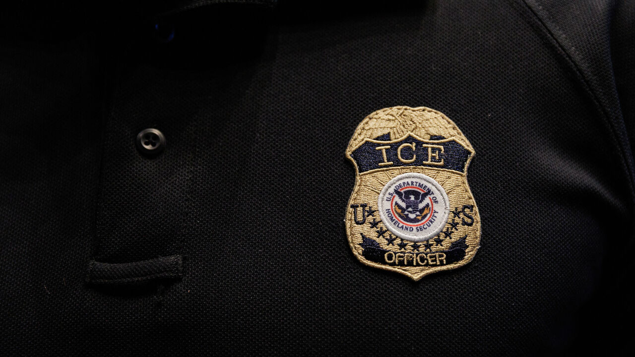 The badge of a U.S. Immigration and Customs Enforcement (ICE) is embroidered on a polo shirt of an ICE employee, at a U.S. Immigration and Customs Enforcement  two-day job fair in Texas to help fill vacancies for deportation officers and attorneys, in Arlington, Texas, U.S. August 26, 2025.  REUTERS/Shelby Tauber