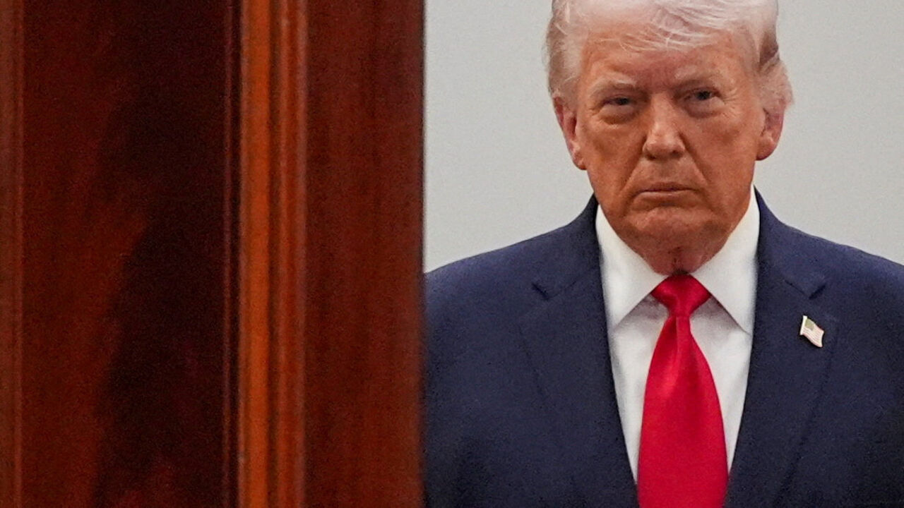 FILE PHOTO: President Donald Trump arrives from the Blue Room to speak about the Iran war from the Cross Hall of the White House on Wednesday, April 1, 2026, in Washington.     Alex Brandon/Pool via REUTERS/File Photo