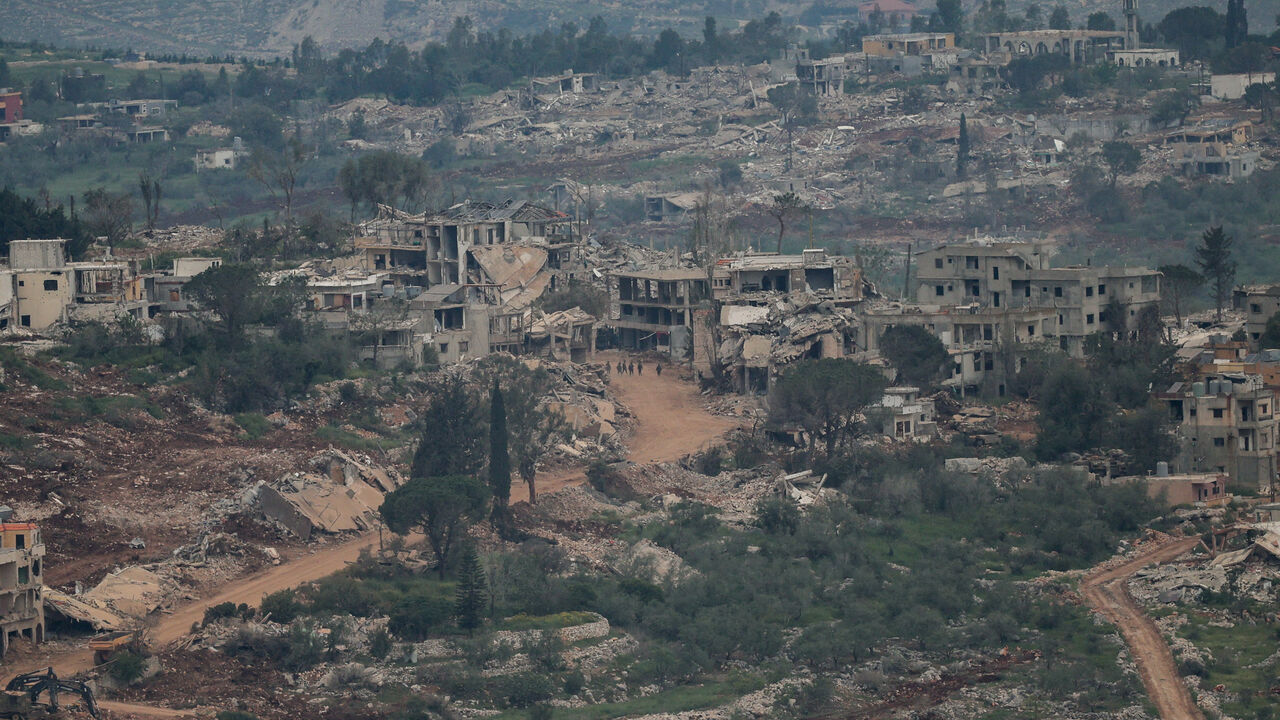 Israeli soldiers walk amid destroyed buildings in Lebanon, as seen from the Israeli side of the Israel-Lebanon border, in northern Israel, April 26, 2026. REUTERS/Shir Torem      TPX IMAGES OF THE DAY
