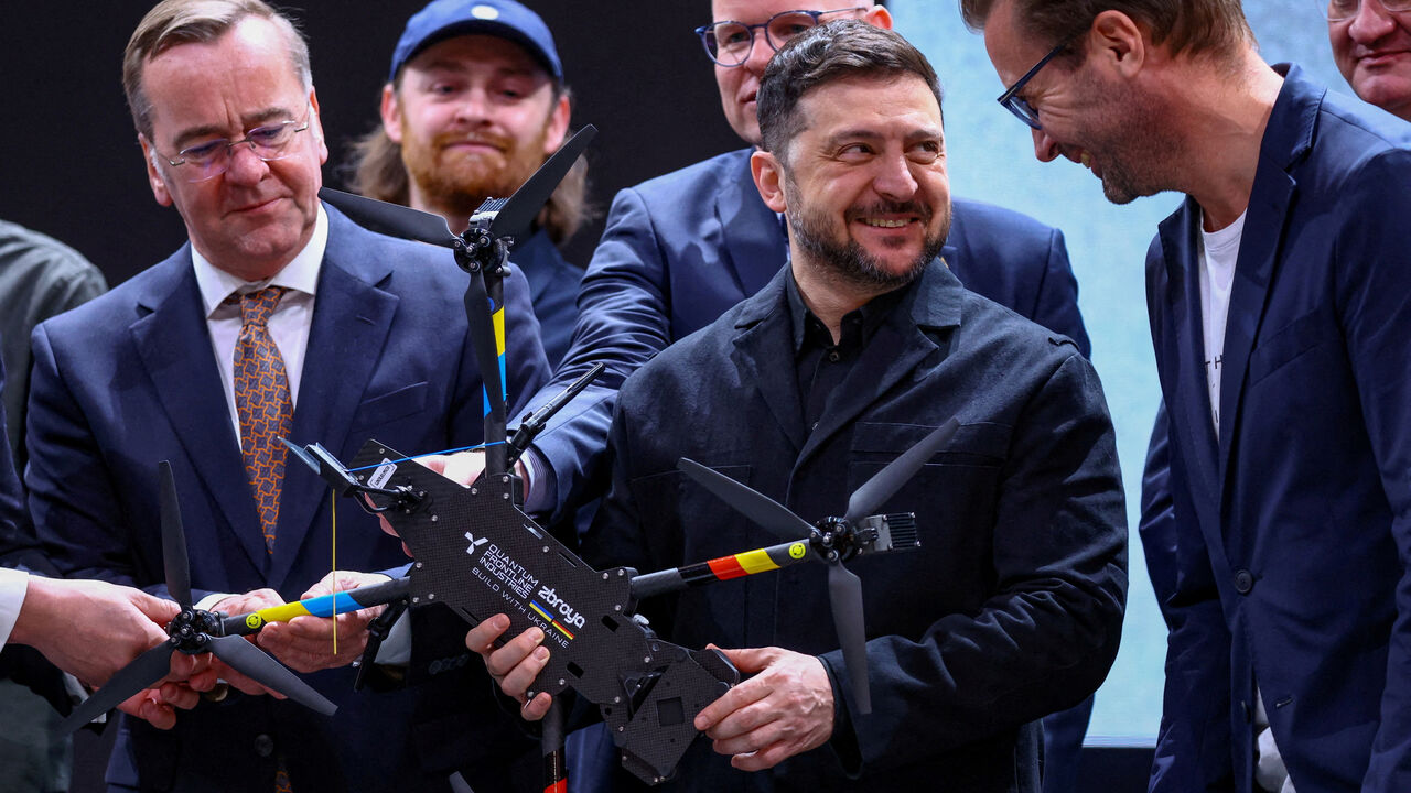 FILE PHOTO: Ukrainian President Volodymyr Zelenskiy holds a drone of German drone maker Quantum Systems, along with Germany's Defence Minister Boris Pistorius, during a visit to the firm on the sidelines of the annual Munich Security Conference (MSC), near Munich, Germany, February 13, 2026. REUTERS/Thilo Schmuelgen/File Photo