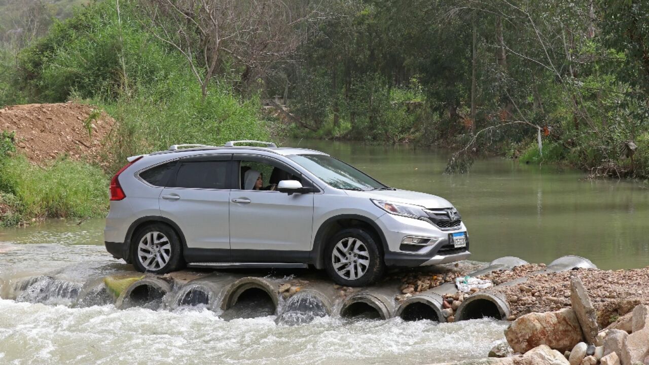 Displaced people drive back to their homes across the Litani river in southern Lebanon