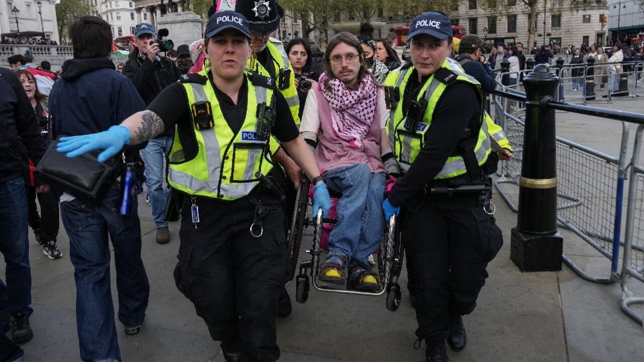 Officers carried away activists to cheers and clapping from other demonstrators at the sit-down demonstration