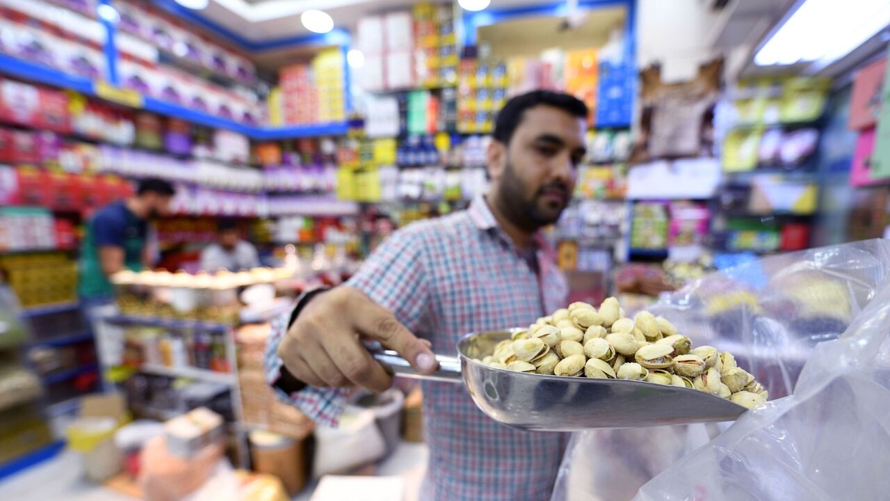 An Iranian grocer sells pistachios imported from Iran at a Persian products shop in the Gulf emirate of Dubai on July 10, 2019. (Photo by Karim SAHIB / AFP) (Photo credit should read KARIM SAHIB/AFP via Getty Images)