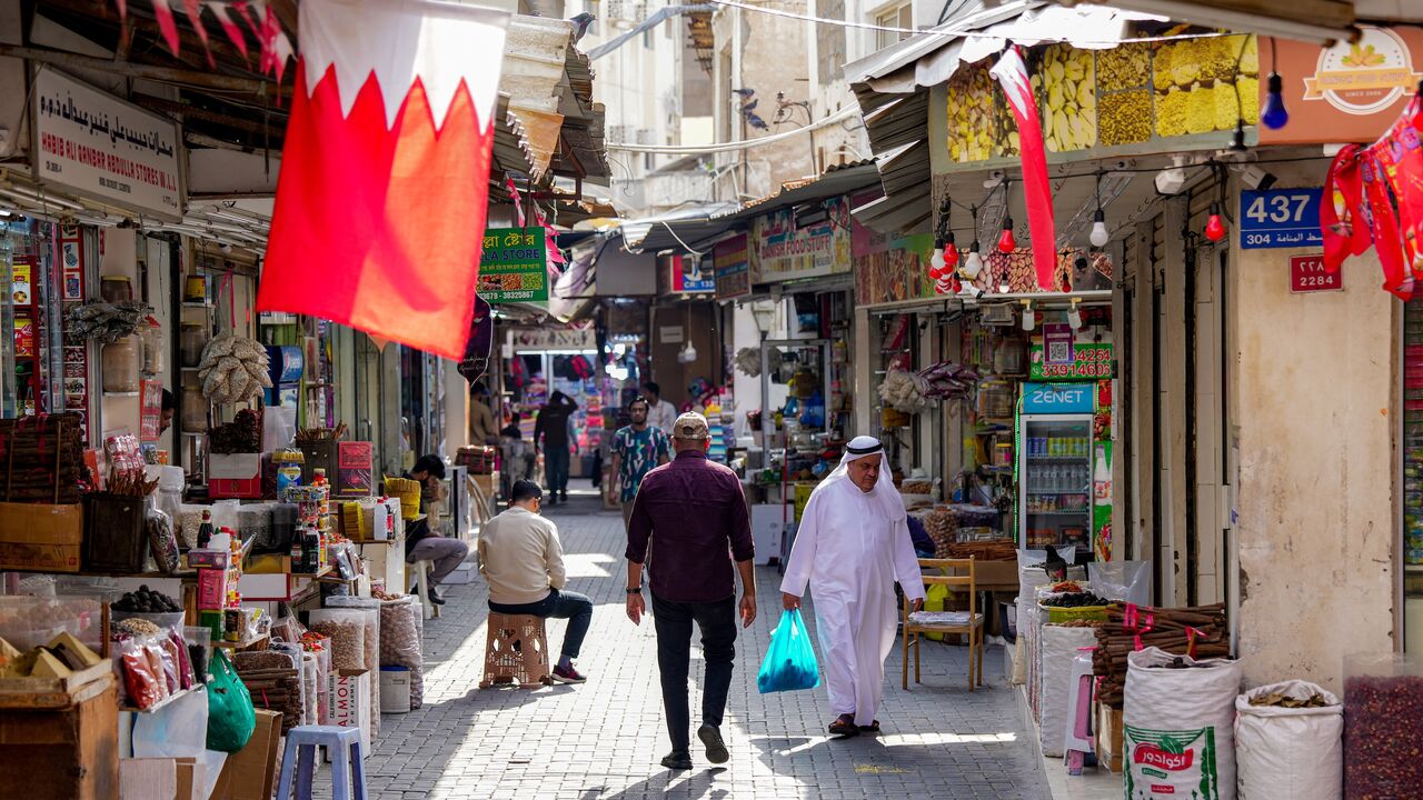 People walk along an alley at a bazaar in Bahrain's capital, Manama, on March 11, 2026. 