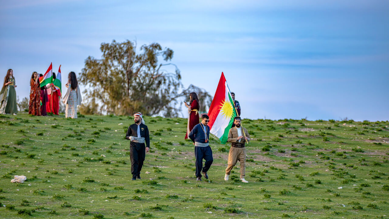 Kurdish people waving Kurdistan flags gather to celebrate Nowruz on the hill of Urkesh in the countryside of Amuda in northeastern Syria on March 18, 2026. Nowruz, meaning "new day," is an ancient festival that marks the start of spring and the new year on the vernal equinox, which usually falls on March 20 or 21. It is celebrated by more than 300 million people worldwide and has been observed for over 3,000 years across regions including the Middle East, Central Asia, the Caucasus and parts of Eastern Euro