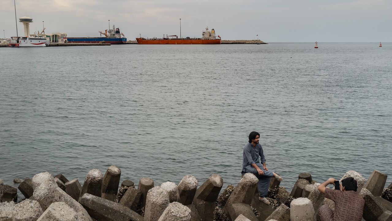 People celebrate Eid and watch oil tankers sail into Muscat Anchorage on March 22, 2026, at Sultan Qaboos Port in Muscat, Oman.