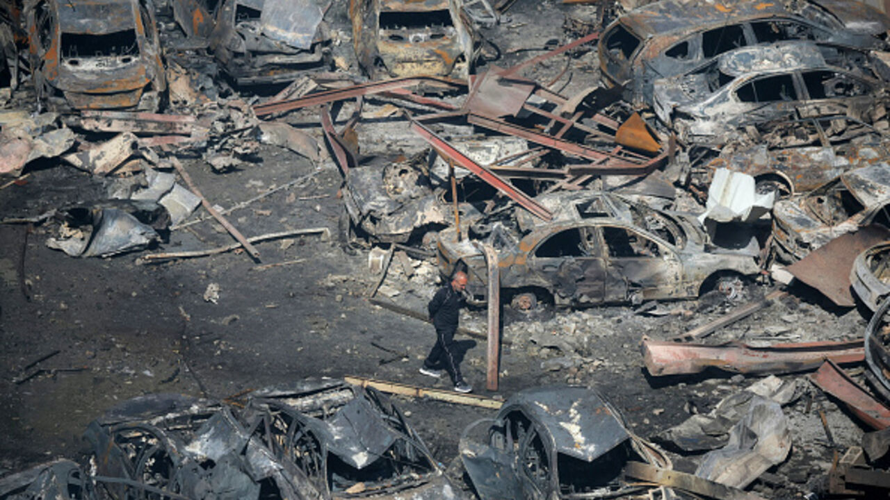 A Lebanese man walks amid charred cars at the site of an Israeli airstrike that targeted a building the day before in Beirut's Corniche al-Mazraa neighbourhood on April 9, 2026. (Ibrahim AMRO / AFP via Getty Images)