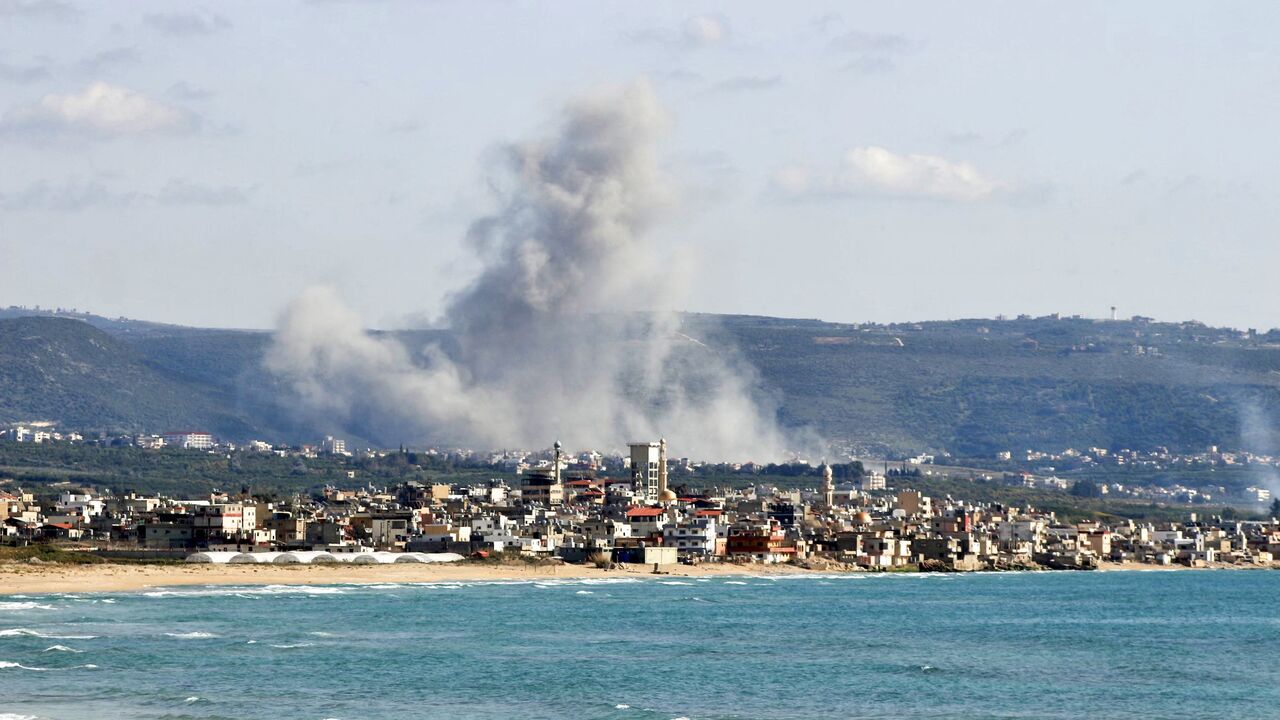 This photograph taken from the southern Lebanese area of Tyre shows smoke as it rises from the site of an Israeli airstrike that targeted the village of Qlaileh on April 13, 2026.