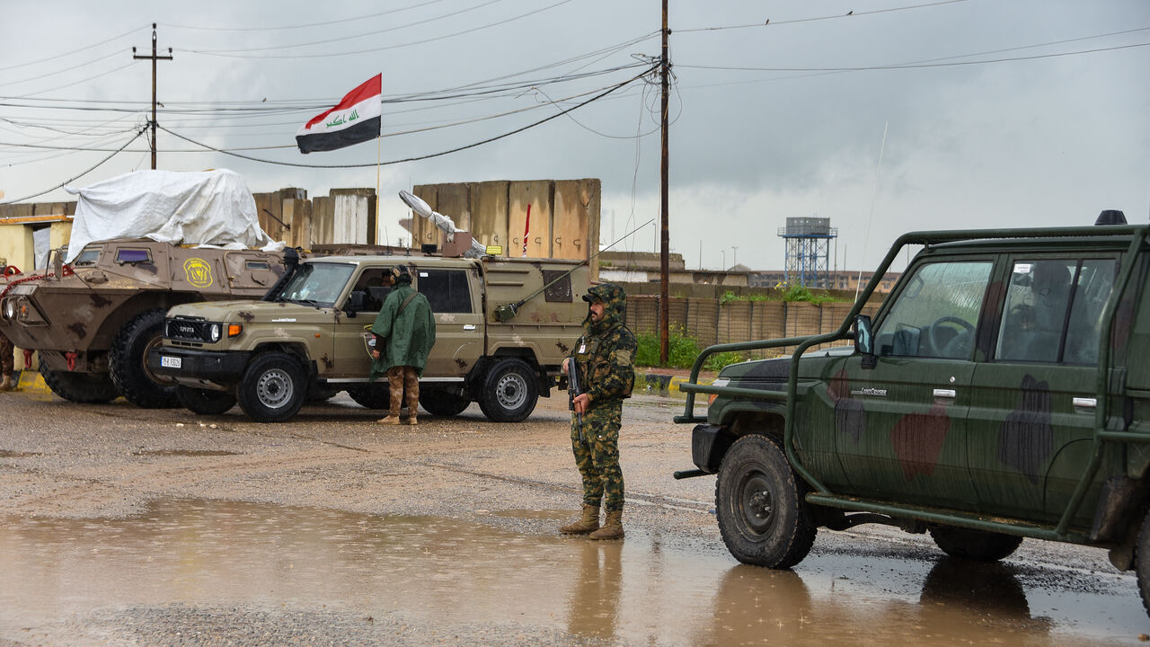 Members of Iraq's security forces stand guard on the the al-Rabia border crossing with Syria on April 20, 2026. 
