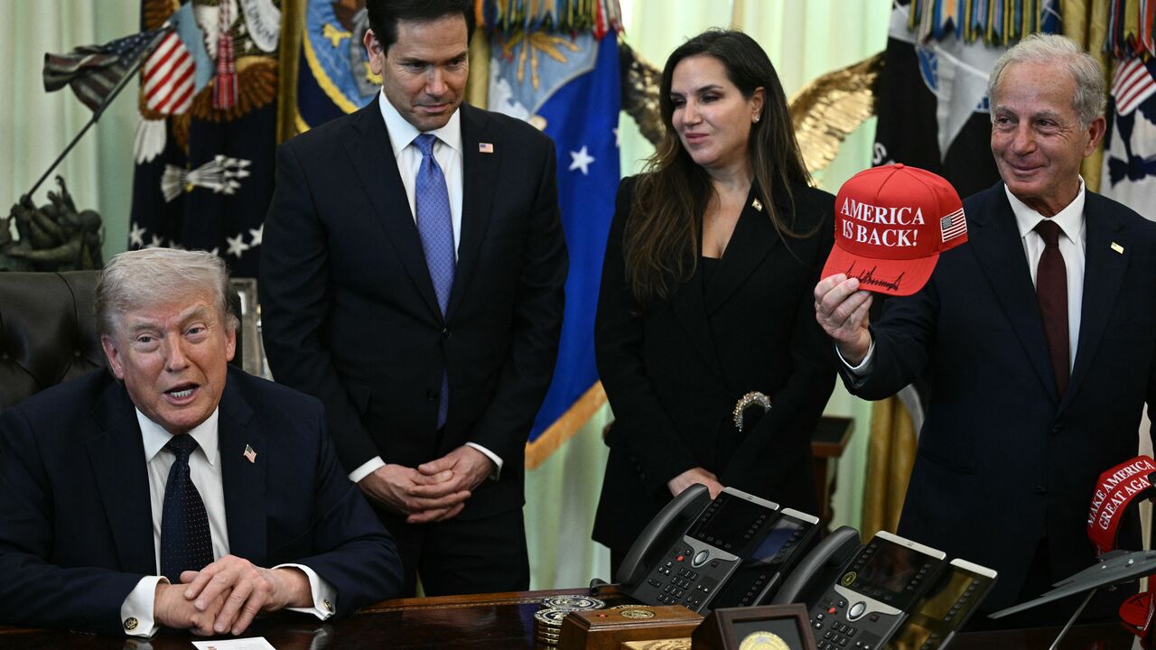US Ambassador to Lebanon Michel Issa (R) holds a signed "Make America Great Again" hat while (L-R) US Secretary of State Marco Rubio and Lebanon Ambassador to the US Nada Hamadeh Moawad listen to US President Donald Trump speak during a meeting with Lebanon Ambassador to the US and Israel Ambassador to the US, at the White House in Washington, DC on April 23, 2026. US President Donald Trump met Lebanese and Israeli envoys at a new round of peace talks Thursday, with Beirut seeking a one-month extension of a