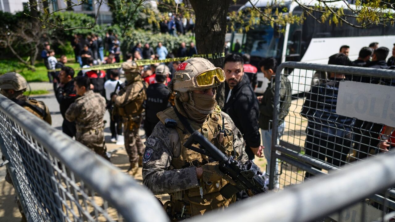 A police officer stands guard outside the Israeli consulate in Istanbul after the shootout
