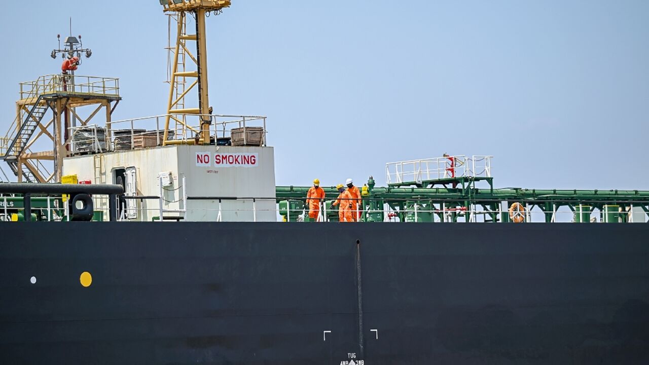 Sailors work on the deck of the Indian-flagged tanker Desh Garima, carrying crude oil that transited through the Strait of Hormuz