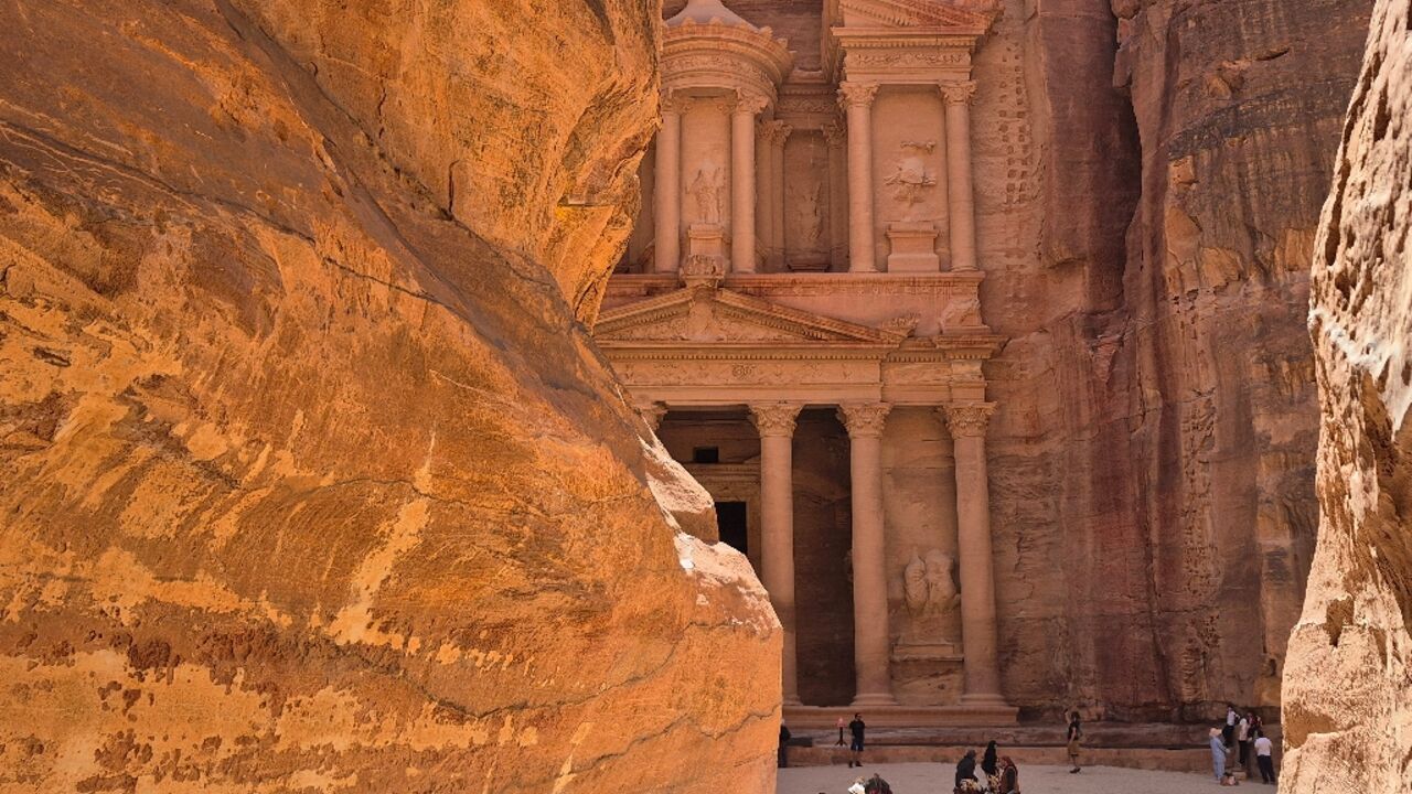 Tourists visit the Treasury in the ruins of the ancient Nabatean city of Petra, in southern Jordan