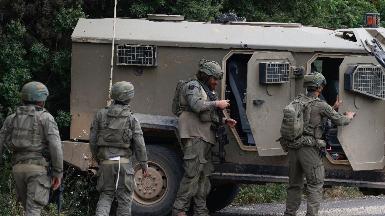 Israeli soldiers took cover near the Israel-Lebanon border following a Hezbollah drone attack