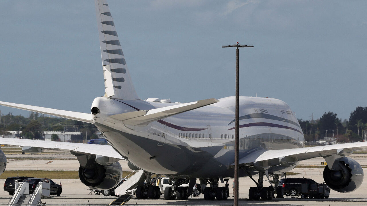 FILE PHOTO: The motorcade of U.S. President Donald Trump is parked next to a 12-year-old Qatari-owned Boeing 747-8 that Trump was touring in West Palm Beach, Florida, U.S., February 15, 2025. REUTERS/Kevin Lamarque/File Photo