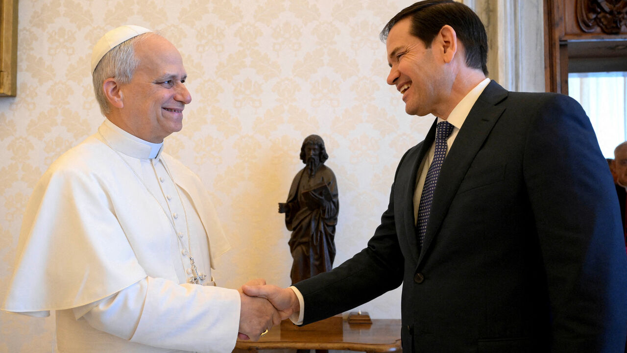 FILE PHOTO: Pope Leo XIV shakes hands with U.S. Secretary of State Marco Rubio as they meet at the Vatican, May 19, 2025. Vatican Media/­Simone Risoluti/Handout via REUTERS /File Photo
