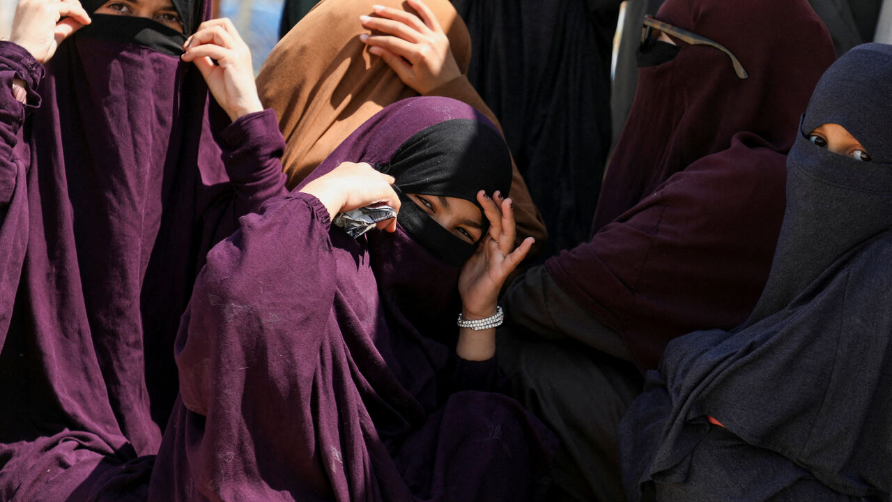 Members of Australian families believed to be linked to the Islamic State militants wait to leave Roj camp near Derik, Syria April 24, 2026. REUTERS/Orhan Qereman